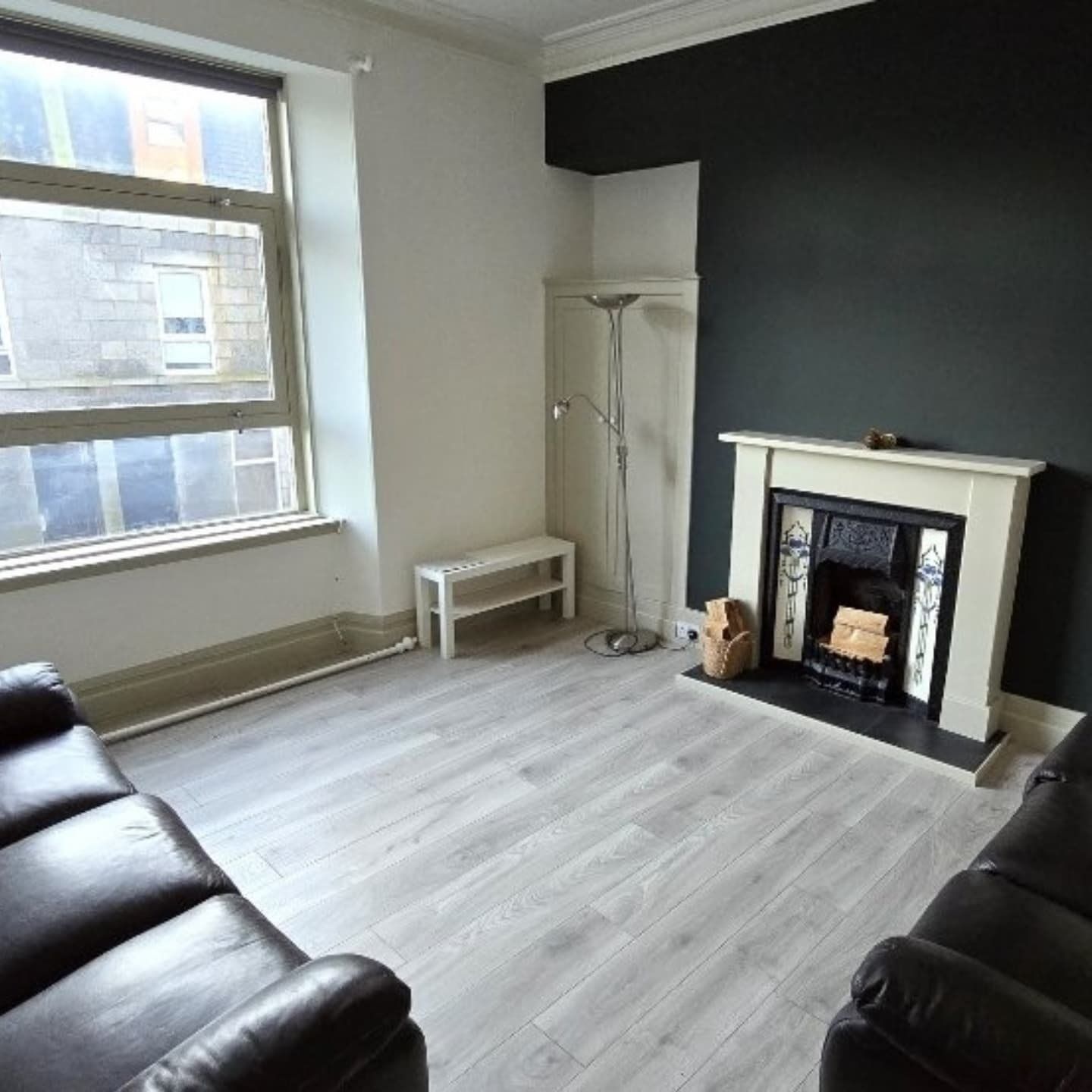 Finished living room with a fireplace at Project Hollybank